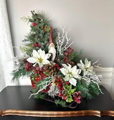 Christmas Santa Centerpiece Arrangement, Holiday Sleigh Table Arrangement, Christmas Tree Centerpiece, Old St Nick Table Decor, Red Berries What a delightful centerpiece for your table this year! Santa, aka Old St Nick, is riding in his Christmas Sleigh with his decorated Christmas tree, full of bright red berries, and glittered white poinsettias to match his sleigh. There are pretty ornaments tucked in, and pine cones, as well as long pine and fir boughs, and snowy winter branches tucked in. The sleigh has antique-look metal runners and a vintage image on its sides. Perfect for the season! "Why not let me help you with decorating your home or office this season? How wonderful to come home to a beautiful Winter arrangement in your foyer or on your table! Even dreary days become brighter wh Christmas Sleigh Arrangements, Christmas Sleigh Centerpiece, Santa Centerpiece, Snow Berries, Christmas Arrangements Centerpieces, Pretty Ornaments, Winter Branches, Winter Centerpiece, Tree Centerpiece