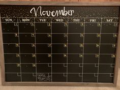 a black calendar with gold glitters on it and the word november written in white