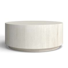 a white round table sitting on top of a wooden floor