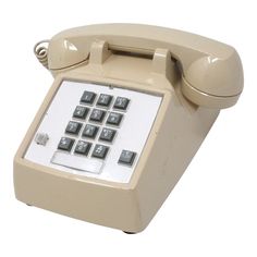 an old - fashioned telephone is shown with buttons on the front and back panel,