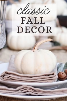 a white pumpkin sitting on top of a table next to other plates and napkins