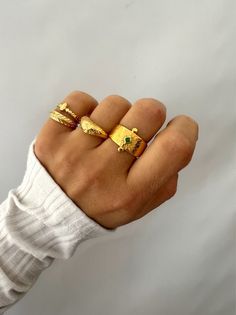 Four Different Gold Rings in unique designs and different width that create a unique set for every woman. The first one has a rhombus shape with a green stone from enamel at the center, the second one is a solid floral ring, the third one is a tiny ring with a tear at the centerand finally a leaf ring that completes this unique set. All of them are slightly adjustable except the thin ring that has standard dimensions. Find them only at Christina Christi Store. MATERIALS - Pewter. DIMENSIONS - Ri Gold Band Rings Women, Stackable Rings Gold, Gold Stackable Rings, Band Rings Women, Handmade Gold Ring, Ring Minimal, Rhombus Shape, Gold Glasses, Rings Women