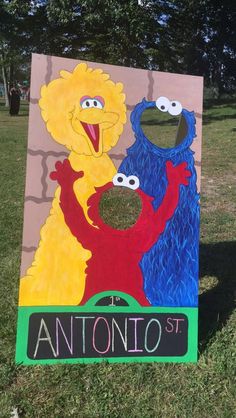 a cardboard cutout of two sesame street characters and the words antonio st on it