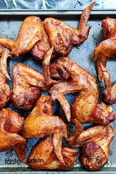 chicken wings on a baking sheet ready to be cooked in the oven for roasting