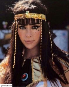 a close up of a person wearing a head piece with beads on it's head