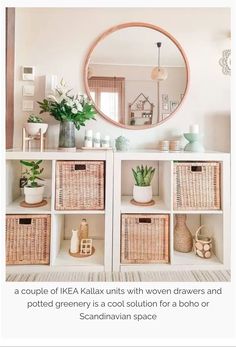 a white shelf with baskets and plants on it in front of a large round mirror