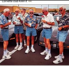 five men in shorts and shirts standing next to each other