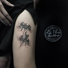 a woman with a tattoo on her arm holding onto a black and white flower bouquet