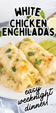 white chicken enchiladas on a plate with lime wedges