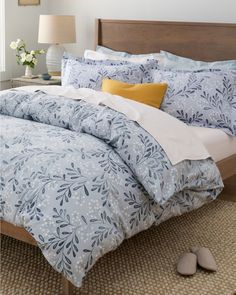 a bed with blue and white comforters in a bedroom