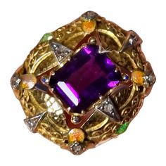 Art Nouveau Amethyst Ring with Enamel & Diamonds Art Nouveau jewelry is instantly recognizable by its embrace of natural forms and its focus on expert techniques, particularly exquisite enamel work. The Art Nouveau and related Arts and Crafts movements celebrated the beauty of all things handmade. Gold and silver were manipulated to a softness that seemed alive. Fabulous hammer gold work and delicate enamel mount ring. A rich, deep purple faceted amethyst; measurements: 9.17X8.06X6.80mm, emerald Art Deco Enamel Ring As A Gift, Art Deco Enamel Ring As Gift, Art Deco Enamel Ring Jewelry, Art Deco Enamel Jewelry Ring, Art Deco Enamel Jewelry For Anniversary, Art Deco Multi-stone Collectible Jewelry, Art Deco Hallmarked Enamel Jewelry, Fine Jewelry Purple Cabochon, Artistic Enamel Jewelry For Formal Occasions