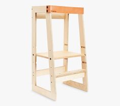 a wooden step stool sitting on top of a white floor next to an open shelf