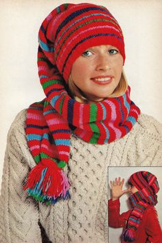 a woman wearing a red and green striped hat, scarf and mittens with matching pom - pom