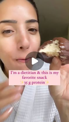 a woman eating a chocolate covered donut with white frosting on her face and the caption reads, i'm a dietn & this is my favorite snack