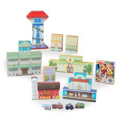 various wooden toys are arranged in the shape of buildings and cars on a white background