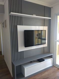 an entertainment center with a flat screen tv mounted on the wall