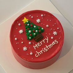 a red cake decorated with a christmas tree