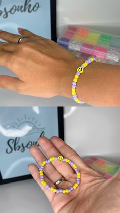 two hands with bracelets that have smiley faces on them, one is holding the other