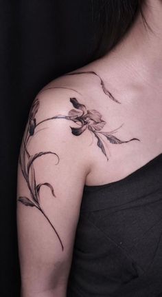 a woman with a flower tattoo on her shoulder