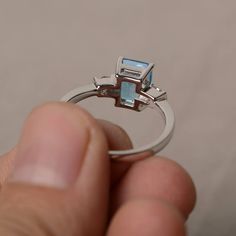 This is a gorgeous handmade creation. Its beauty is its simplicity & Elegance. The 6*8 mm emerald shape faceted Swiss blue topaz is crafted in solid sterling silver and with rhodium plated. All item is sent in a beautiful gift box If you have any idea of design your ring,pls contact me directly. You can realize more lovely stuff clicking the link https://www.etsy.com/shop/knightjewelry?refshopsection_shophome_leftnav Please leave the correct address and you phone number for delivering succes Radiant Cut Blue Topaz Promise Ring, Emerald Cut Sterling Silver Topaz Ring As Gift, Asscher Cut Blue Topaz Gemstone Rings, Baguette Cut Topaz Ring Gift, Silver Topaz Ring With Rectangular Blue Stone, Silver Blue Topaz Ring With Rectangular Stone, Silver Blue Topaz Ring With Emerald Cut, Silver Emerald-cut Blue Topaz Ring, Gift Radiant Cut Blue Topaz Ring