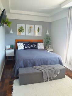 a bed room with a neatly made bed and two pictures on the wall above it