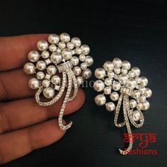 Silver Pearl Cubic Zirconia Designer Studs Made in Brass in Rhodium finish with very high quality Cubic Zirconia Stones and Pearls Length: Approx. 2.15" Light-weight Earrings Earrings come with Push Back Closure Suitable for any traditional for contemporary attire and occasion In-stock & ready-to-ship **Color may vary slightly due to photography and lighting.