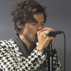 a person that is singing into a microphone