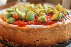 a cake with avocado on top sitting on a plate