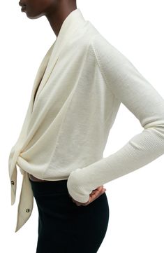 Feel the warmth and sophistication of this perfectly wrapped cardi knit from soft merino wool. Front button closure Shawl collar 100% merino wool Dry clean Imported Elegant Soft Knit Long Sleeve Cardigan, Cream Merino Wool Cardigan For Fall, Elegant Merino Wool Sweater For Work, Chic Wool Cardigan For Layering, Spring Merino Wool Fine Knit Outerwear, Elegant Merino Wool Outerwear For Spring, Chic Cashmere Cardigan, Merino Wool Sweater For Spring Workwear, Versatile Merino Wool Winter Sweater