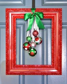 a red frame with christmas ornaments hanging from it's side and the words pinterest framed christmas wreath