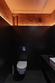 a white toilet sitting in a bathroom next to a sink