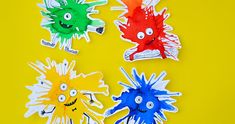 four different colored paper monsters on a yellow background