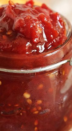 a jar filled with sauce sitting on top of a table