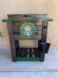 a wooden crate with the seal of the united states on it and a bucket next to it