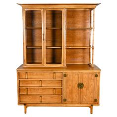 a wooden cabinet with glass doors and drawers