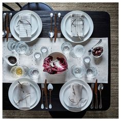 an overhead view of a dining table set with plates, silverware and utensils