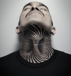 a man's neck is covered in black and white lines, with his eyes closed