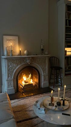 a living room filled with furniture and a fire place in the middle of the room