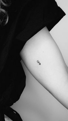 a small apple tattoo on the left arm