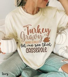 Celebrate Friendsgiving and Turkey Day in style with this Thanksgiving funny shirt that says "Turkey Gravy Beans & Rolls Let Me See That Casserole" on a comfy Comfort Colors fall shirt. Perfect for adding humor to your holiday gathering, this Friendsgiving shirt is a must-have for anyone who loves Thanksgiving tees with a playful twist. Whether you're rocking it at a family dinner or a Friendsgiving feast, this fall crewneck shirt brings comfort and laughs. Designed as the perfect thanksgiving shirt for women, it's one of the best turkey day t-shirts for the season! 🦃  ✨ Please see listing photos for sizing information. - 100% ring-spun US cotton for long-lasting comfort. - Relaxed fit - Direct-to-garment print - Runs true to size- If you are looking for a more oversized fit, I recommend Friendsgiving Shirt, Thanksgiving Shirts For Women, Friendsgiving Feast, The Best Turkey, Thanksgiving Funny, Fall Crewneck, Funny Thanksgiving Shirts, Best Turkey, Thanksgiving Tee