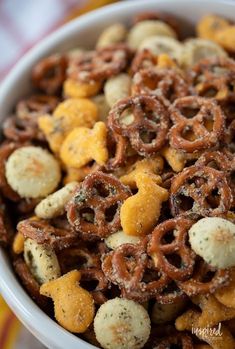 a white bowl filled with cheetos and pretzels