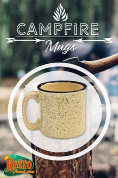 a coffee mug sitting on top of a tree stump with the words campfire mugs over it