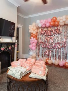 there is a table with some pink and white items on it in the living room