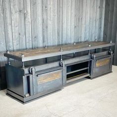 an entertainment center made out of metal and wood