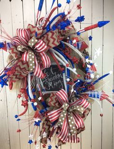 a patriotic wreath with red, white and blue streamers