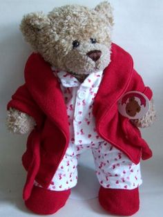 a teddy bear dressed in red and white pajamas