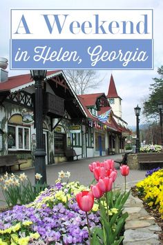 a sign that says a weekend in helen, georgia with flowers on the side walk