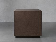 a brown box sitting on top of a cement floor