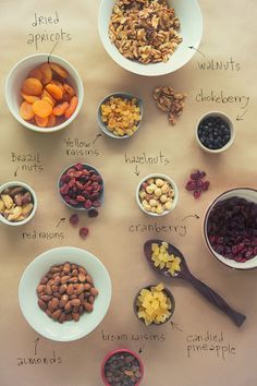 bowls filled with different types of nuts and dried fruits