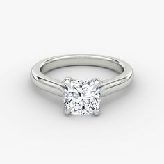 a white gold ring with a square cut diamond